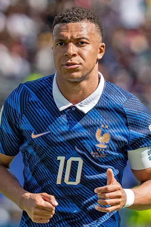 Mbappé marks 100th cap in style as France overcome storm and Iraq