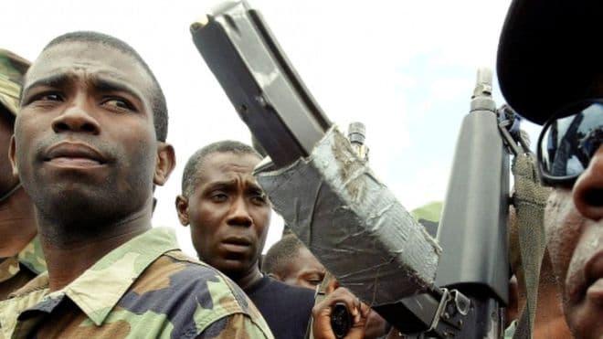 Extradited Haitian rebel leader argues case from behind bars