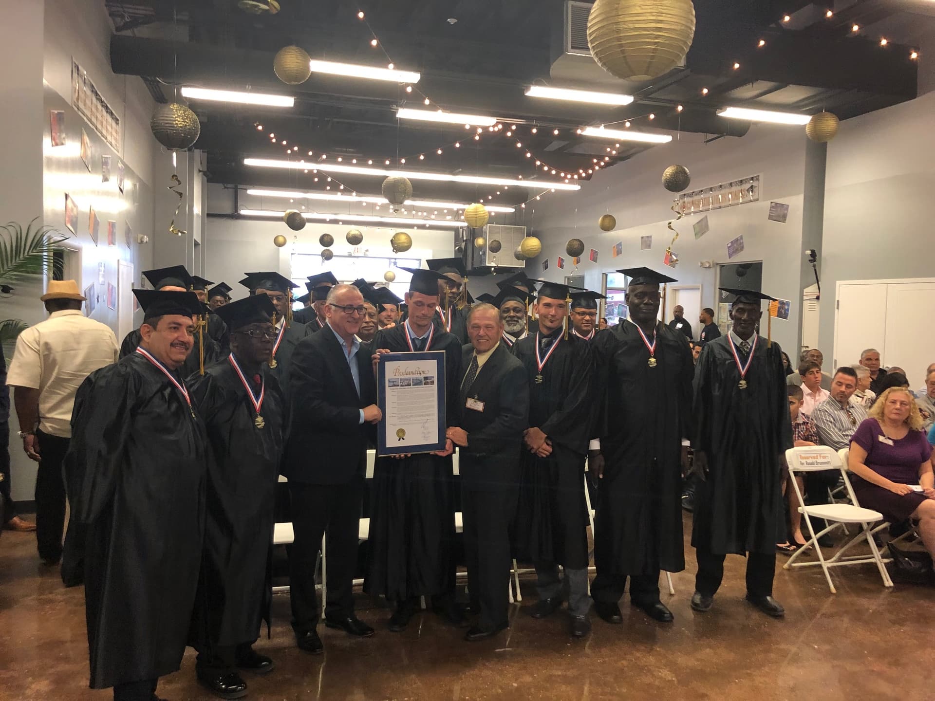 Nearly 50 Formerly Homeless Graduate with Cap & Gown Miami Rescue Mission