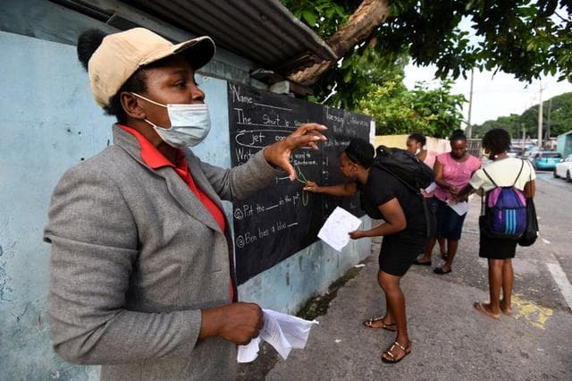 Jamaican Teacher Turns Kingston Walls into Blackboards for Students