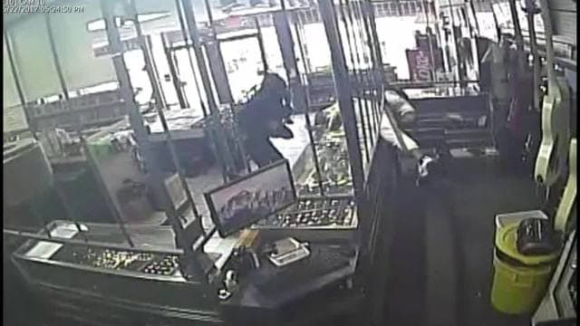 Customers caught in crossfire during pawn shop robbery
