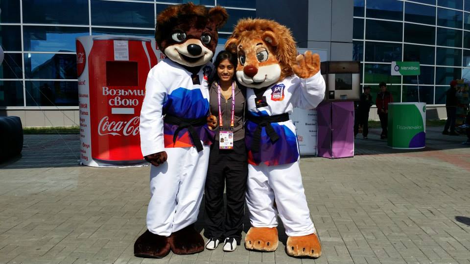 Trini-American Melissa Joseph stands with mascots at the Tae Kwon Do World Championships 2015 held in Russia