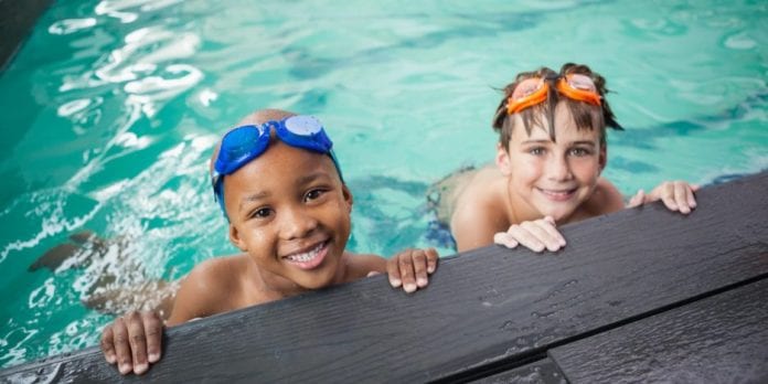 two little boys in a pool on independence day in the US