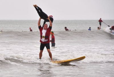 Frigid weather doesn’t stop Santas surfing off Florida coast