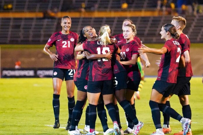 Canada celebrate win with a group hug - JAMAICA VS CANADA - OLYMPIC PLAYOFF