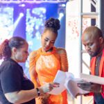 Terri-Karelle, host of Digicel Rising Stars looks over her final script with her producer Sharon Schroeter. On hand is Alex Sterling, Executive Liaison to Terri-Karelle