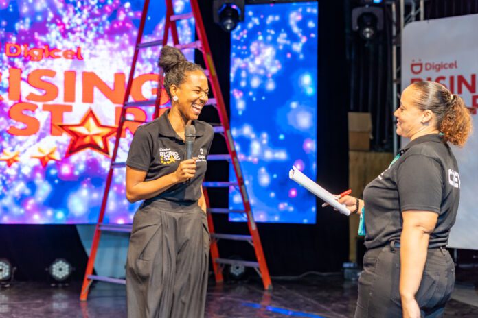 Terri-Karelle shares a laugh with her producer Sharon Schroeter during her final technical rehearsal for the 19th season of Digicel Rising Stars