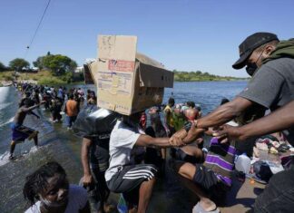 Caribbean migrants urged to choose legal routes to enter the US Haitian migrants use a dam to cross to and from the United States from Mexico, Friday, September 17, 2021, in Del Rio, Texas.