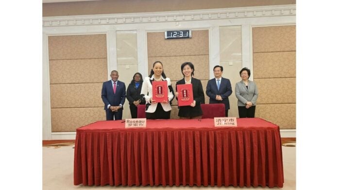 Minister of Housing and Urban Development Melissa Poponne-Skerrit (left) and Vice Governor of Shandong Province, Chen Ping following the signing of an MOU that twinned Roseau and Jining City.