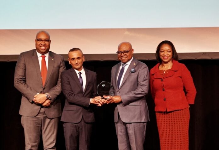 Minister of Tourism, Hon Edmund Bartlett receives the Global Destination of the Year award from Yatan Ahluwalia, Secretary General, PATWA. Sharing in the moment are (l-r) Delano Seiveright, Senior Strategist and Advisor, Ministry of Tourism and Chevannes Barragan De Luz, Business Development Manager, Continental Europe.