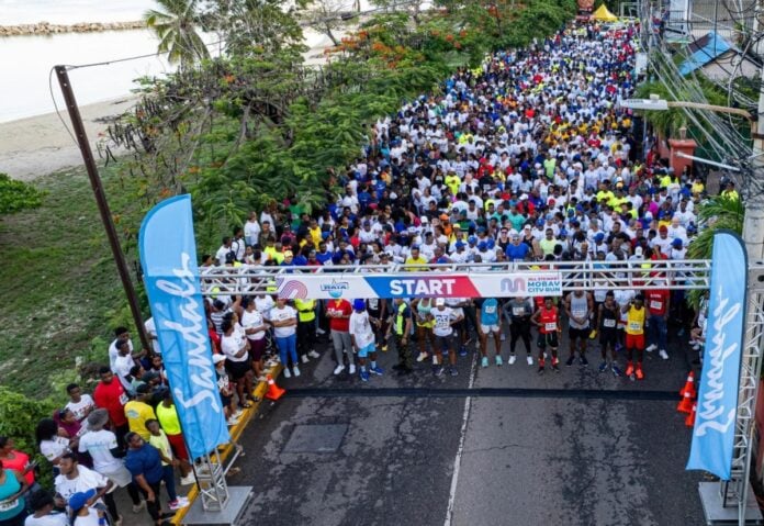 Thousands of persons assemble at the start line for the Jill Stewart MoBay City Run in the St. James capital on Sunday (May 5).