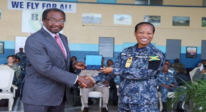 United States Ambassador to Jamaica N Nick Perry (left) officially presents the key to a jet fuel truck to Jamaica’s Chief of Defence Staff, Vice Admiral Antonnette Wemyss Gorman.