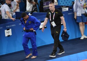 CAPTION: Jamaica’s Ashley McKenzie (blue gear) competes with Turkey’s Salih Yaldis during their round of 16 match on Saturday.