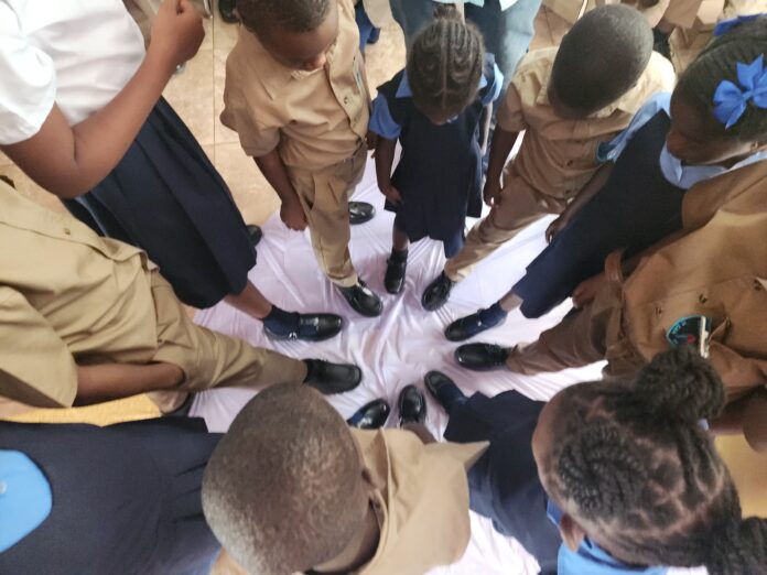 Students wuth their new shoes in Mandeville 2025