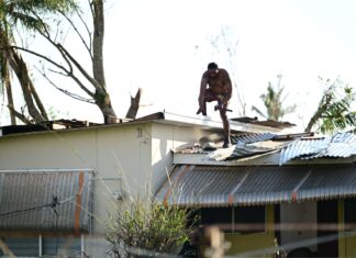 Jamaica’s economy shrinks 5.9% in first quarter as Hurricane Melissa fallout persists A resident in Black River, St. Elizabeth, repairs his roof in the aftermath of Hurricane Melissa.